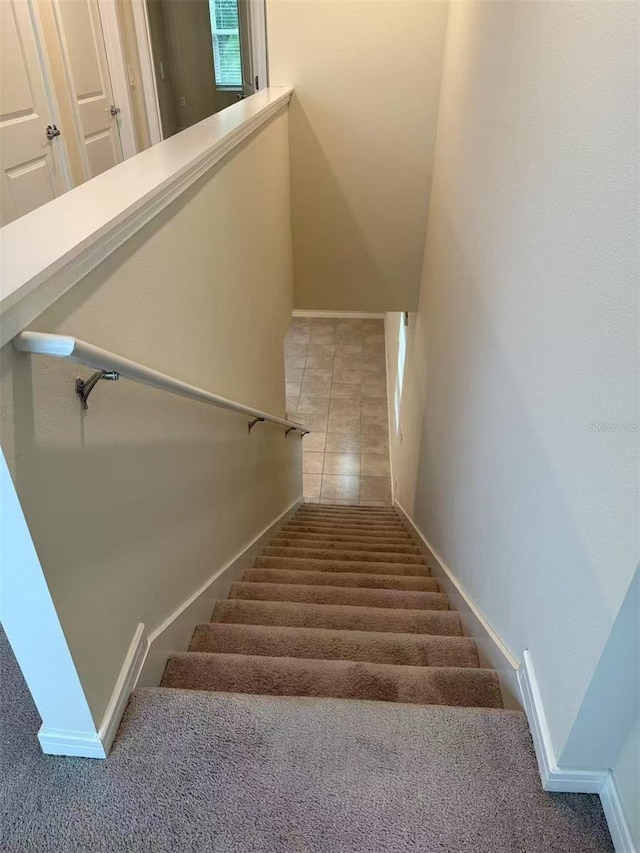 905 Rivers Crossing St, Clermont, FL 34714 - stairway with baseboards and tile patterned flooring