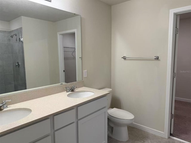 905 Rivers Crossing St, Clermont, FL 34714 - full bathroom with double vanity, a tile shower, a walk in closet, and tile patterned flooring