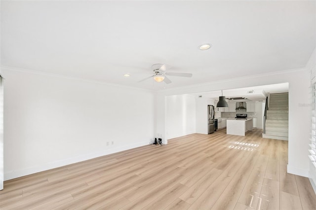 9410 Tara Cay Ct Unit 15, Seminole, FL 33776 - unfurnished living room with ceiling fan, ornamental molding, light wood-style flooring, and recessed lighting