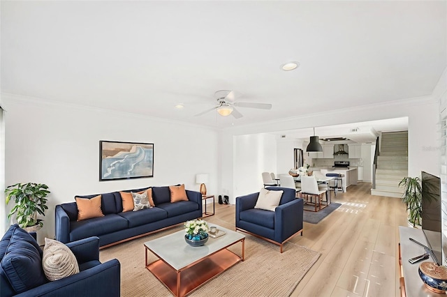 9410 Tara Cay Ct Unit 15, Seminole, FL 33776 - living room featuring a ceiling fan, crown molding, light wood-type flooring, and recessed lighting