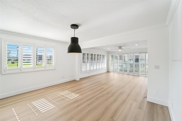 9410 Tara Cay Ct Unit 15, Seminole, FL 33776 - unfurnished living room with ornamental molding, light wood-style floors, a ceiling fan, and a textured ceiling