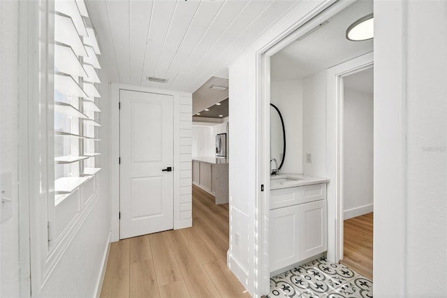 9410 Tara Cay Ct Unit 15, Seminole, FL 33776 - hallway featuring light wood-style floors and wooden ceiling