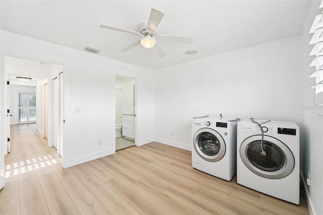 9410 Tara Cay Ct Unit 15, Seminole, FL 33776 - laundry room featuring independent washer and dryer, light wood-style flooring, and ceiling fan