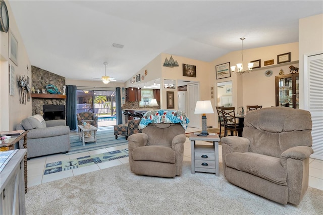 5319 Cordova Way S, Saint Petersburg, FL 33712 - tiled living room featuring a chandelier, lofted ceiling, a stone fireplace, and a ceiling fan