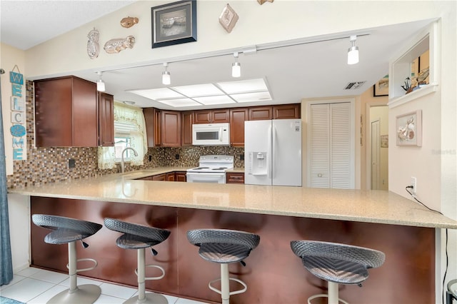 5319 Cordova Way S, Saint Petersburg, FL 33712 - kitchen featuring white appliances, a peninsula, and track lighting