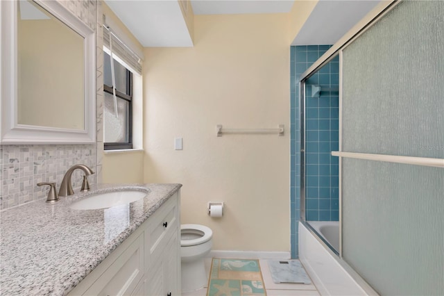 5319 Cordova Way S, Saint Petersburg, FL 33712 - full bathroom with vanity, shower / bath combination with glass door, tile patterned flooring, and decorative backsplash