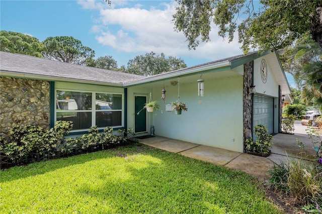 5319 Cordova Way S, Saint Petersburg, FL 33712 - single story home featuring a front lawn, an attached garage, driveway, stucco siding, and stone siding
