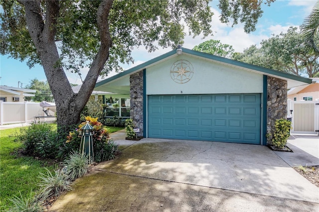 5319 Cordova Way S, Saint Petersburg, FL 33712 - ranch-style house featuring driveway, a garage, stone siding, and stucco siding