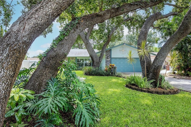 5319 Cordova Way S, Saint Petersburg, FL 33712 - view of front facade featuring stucco siding, a front yard, concrete driveway, and a garage