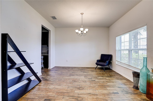 10146 Tuscan Sun Ave, Riverview, FL 33578 - living area with a chandelier, wood finished floors, and a textured ceiling