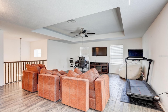 10146 Tuscan Sun Ave, Riverview, FL 33578 - living area featuring ceiling fan, light wood-style floors, and a tray ceiling