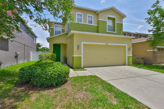 6314 Magnolia Trails Ln, Gibsonton, FL 33534 - view of front facade featuring stucco siding, a garage, and concrete driveway