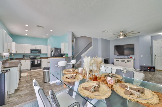6314 Magnolia Trails Ln, Gibsonton, FL 33534 - dining room with light wood-style floors, a ceiling fan, and recessed lighting