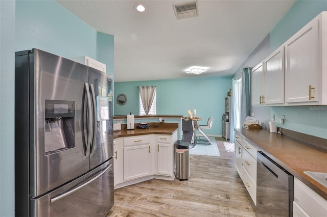6314 Magnolia Trails Ln, Gibsonton, FL 33534 - kitchen with appliances with stainless steel finishes, white cabinets, dark countertops, and recessed lighting