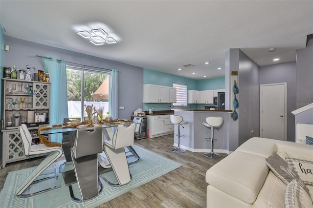 6314 Magnolia Trails Ln, Gibsonton, FL 33534 - dining area with light wood-style flooring and plenty of natural light