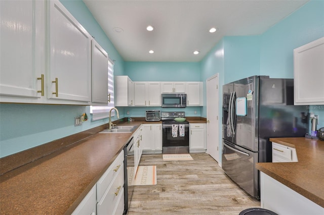 6314 Magnolia Trails Ln, Gibsonton, FL 33534 - kitchen featuring appliances with stainless steel finishes, dark countertops, light wood-type flooring, white cabinets, and recessed lighting