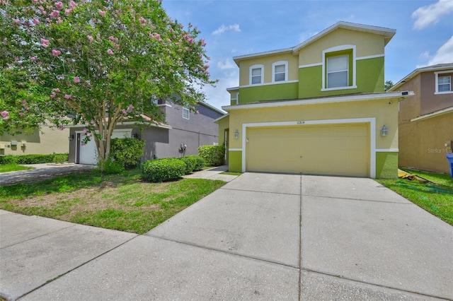 6314 Magnolia Trails Ln, Gibsonton, FL 33534 - traditional-style house featuring stucco siding, a garage, and driveway