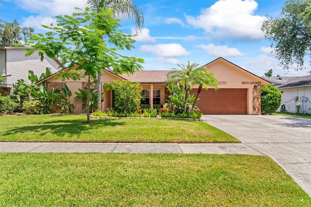 1008 Mallow Way, Brandon, FL 33510 - view of front of property featuring a garage, concrete driveway, and a front yard