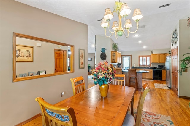 1008 Mallow Way, Brandon, FL 33510 - dining space featuring light wood finished floors and a chandelier
