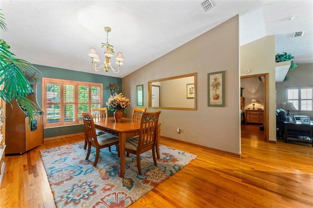 1008 Mallow Way, Brandon, FL 33510 - dining area with a chandelier, vaulted ceiling, and light wood-type flooring