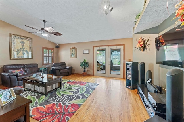 1008 Mallow Way, Brandon, FL 33510 - living room featuring a ceiling fan, a textured ceiling, wood finished floors, french doors, and vaulted ceiling