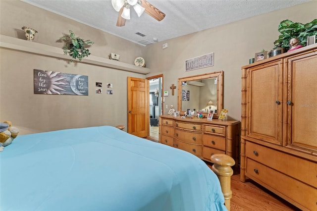 1008 Mallow Way, Brandon, FL 33510 - bedroom with light wood-style flooring, a textured ceiling, and ceiling fan