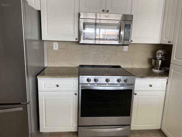 2569 Brazilia Ct, Punta Gorda, FL 33950 - kitchen featuring appliances with stainless steel finishes, white cabinetry, and backsplash