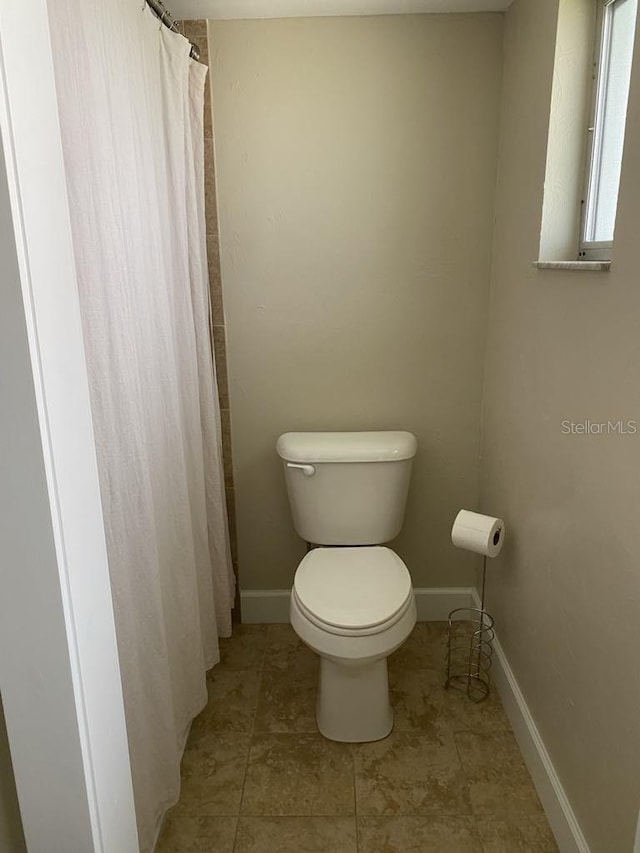 2569 Brazilia Ct, Punta Gorda, FL 33950 - bathroom featuring a shower with curtain and tile patterned flooring