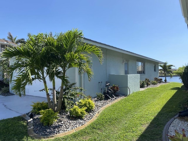 2569 Brazilia Ct, Punta Gorda, FL 33950 - view of home's exterior with stucco siding, a yard, and driveway