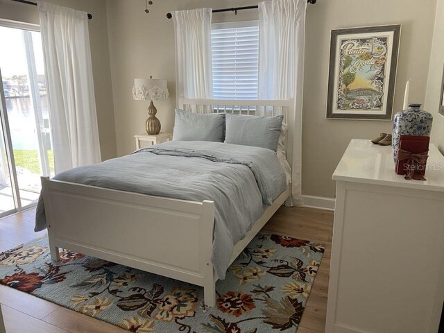 2569 Brazilia Ct, Punta Gorda, FL 33950 - bedroom with light wood-type flooring and access to exterior