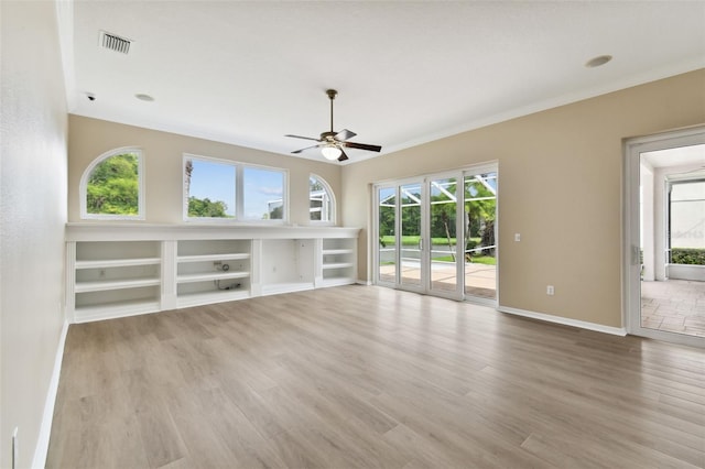 5321 Silver Charm Ter, Wesley Chapel, FL 33544 - unfurnished living room with a ceiling fan, crown molding, wood finished floors, and built in features