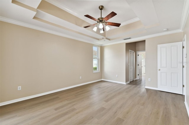 5321 Silver Charm Ter, Wesley Chapel, FL 33544 - unfurnished bedroom with a raised ceiling, light wood-style flooring, and crown molding