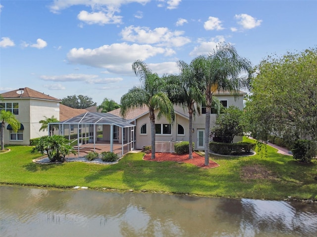 5321 Silver Charm Ter, Wesley Chapel, FL 33544 - back of property with a water view, a detached carport, a lawn, and stucco siding