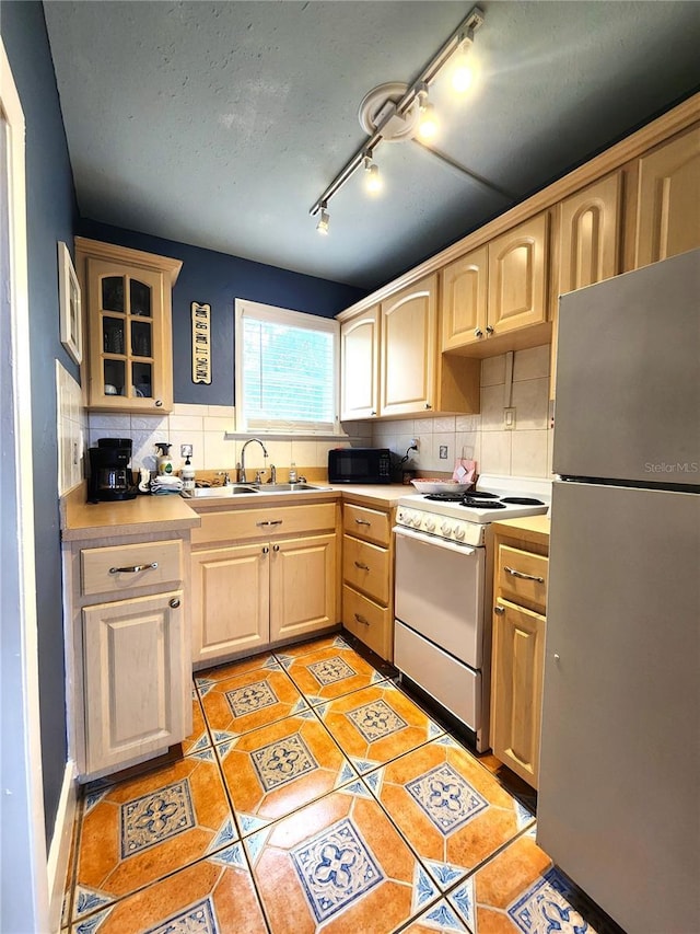 1205 Omaha Cir, Palm Harbor, FL 34683 - kitchen with freestanding refrigerator, electric stove, light brown cabinets, and black microwave