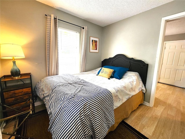 1205 Omaha Cir, Palm Harbor, FL 34683 - bedroom featuring wood finished floors and a textured ceiling