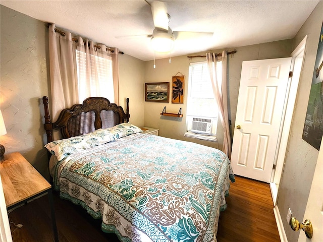 1205 Omaha Cir, Palm Harbor, FL 34683 - bedroom with wood finished floors, cooling unit, ceiling fan, a textured ceiling, and a textured wall