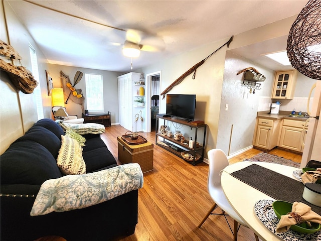 1205 Omaha Cir, Palm Harbor, FL 34683 - living room featuring light wood-style floors and a ceiling fan