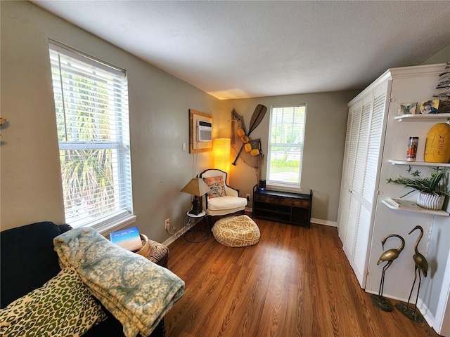 1205 Omaha Cir, Palm Harbor, FL 34683 - living area featuring a wall mounted air conditioner and wood finished floors