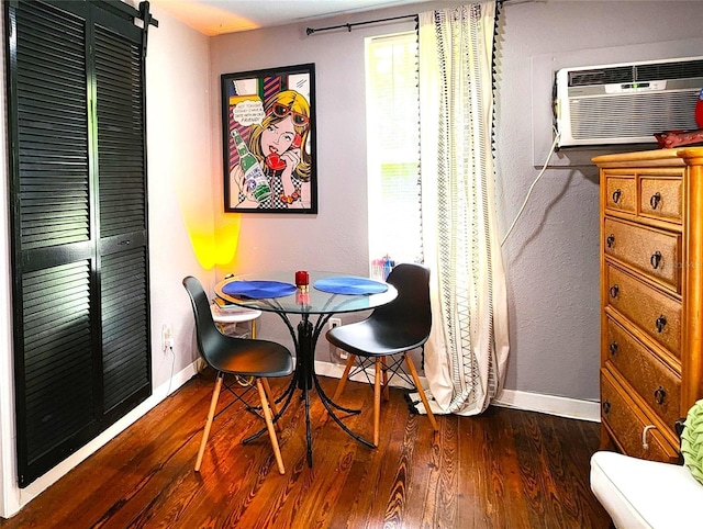 1205 Omaha Cir, Palm Harbor, FL 34683 - dining area featuring wood finished floors, a wall mounted air conditioner, and healthy amount of natural light