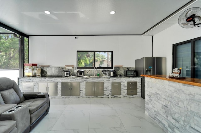 18852 Tracer Dr, Lutz, FL 33549 - kitchen featuring white cabinets, open floor plan, light marble finish floors, recessed lighting, and fridge with ice dispenser