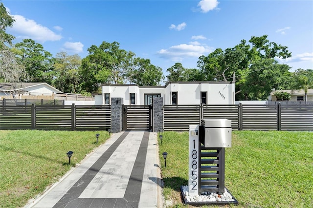 18852 Tracer Dr, Lutz, FL 33549 - view of front facade featuring a front yard, stucco siding, and a gate