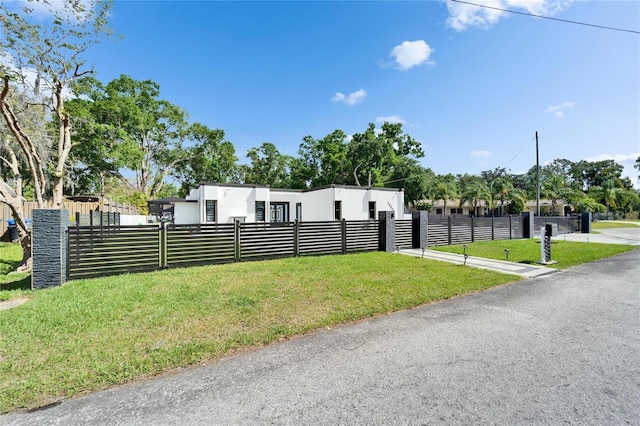 18852 Tracer Dr, Lutz, FL 33549 - modern home featuring a fenced front yard and stucco siding