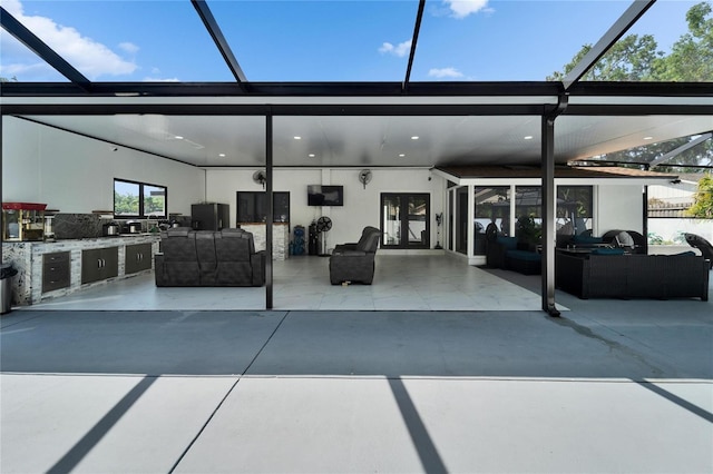 18852 Tracer Dr, Lutz, FL 33549 - view of patio / terrace with outdoor lounge area, a lanai, and exterior kitchen