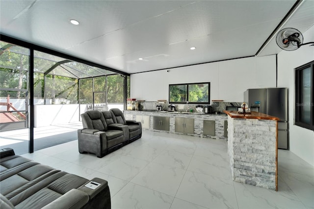 18852 Tracer Dr, Lutz, FL 33549 - living area with light marble finish floors, floor to ceiling windows, and recessed lighting