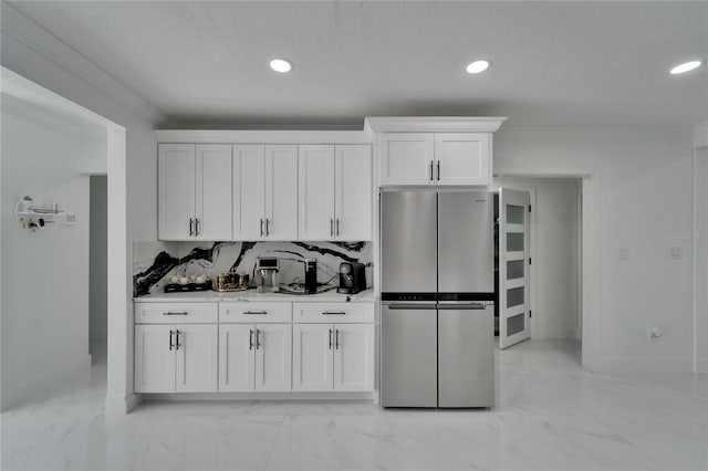 18852 Tracer Dr, Lutz, FL 33549 - kitchen with freestanding refrigerator, light marble finish flooring, white cabinets, recessed lighting, and light countertops