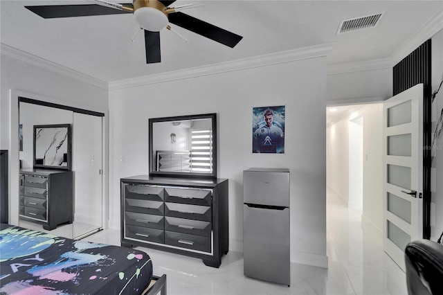 18852 Tracer Dr, Lutz, FL 33549 - bedroom featuring freestanding refrigerator, ornamental molding, light marble finish floors, a closet, and a ceiling fan