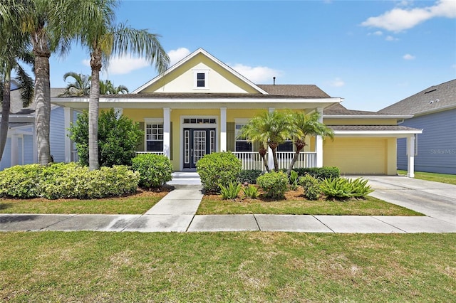 5720 Tortoise Pl, Apollo Beach, FL 33572 - bungalow-style home featuring a front lawn, a garage, a porch, and concrete driveway
