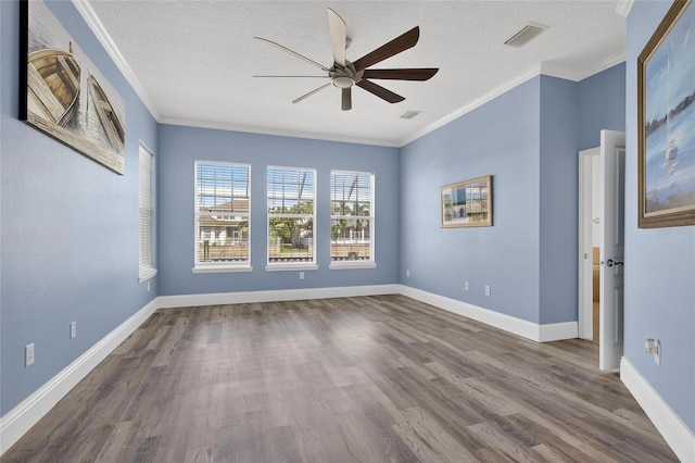 5720 Tortoise Pl, Apollo Beach, FL 33572 - spare room featuring ceiling fan, dark wood-style floors, ornamental molding, and a textured ceiling