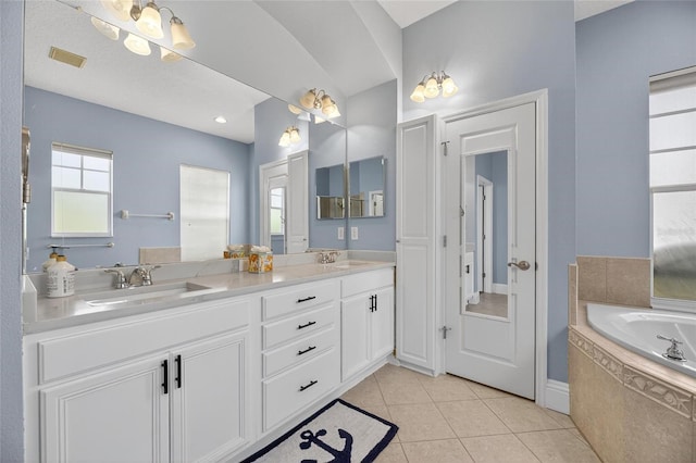 5720 Tortoise Pl, Apollo Beach, FL 33572 - bathroom featuring double vanity, a garden tub, and tile patterned flooring