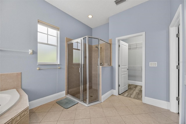 5720 Tortoise Pl, Apollo Beach, FL 33572 - full bath with a stall shower, a garden tub, a walk in closet, and tile patterned flooring